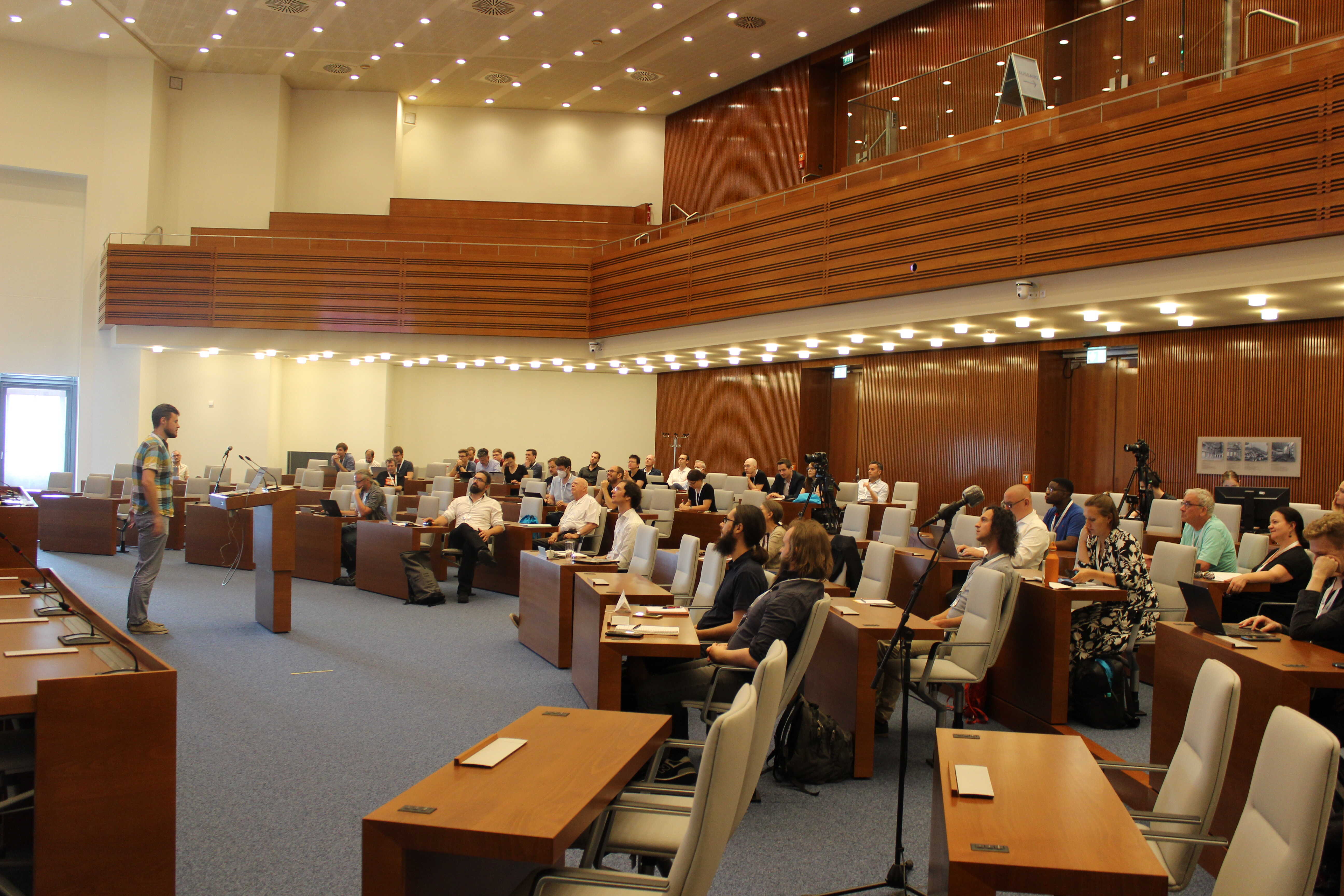 Image of a talk in front of the audience at Sitzungssaal
